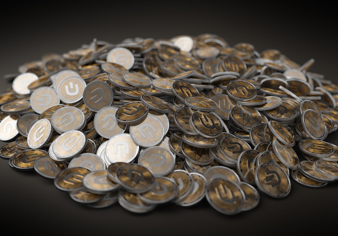 heros-img A close-up view of a large pile of gold and silver cryptocurrency coins indicating financial wealth.