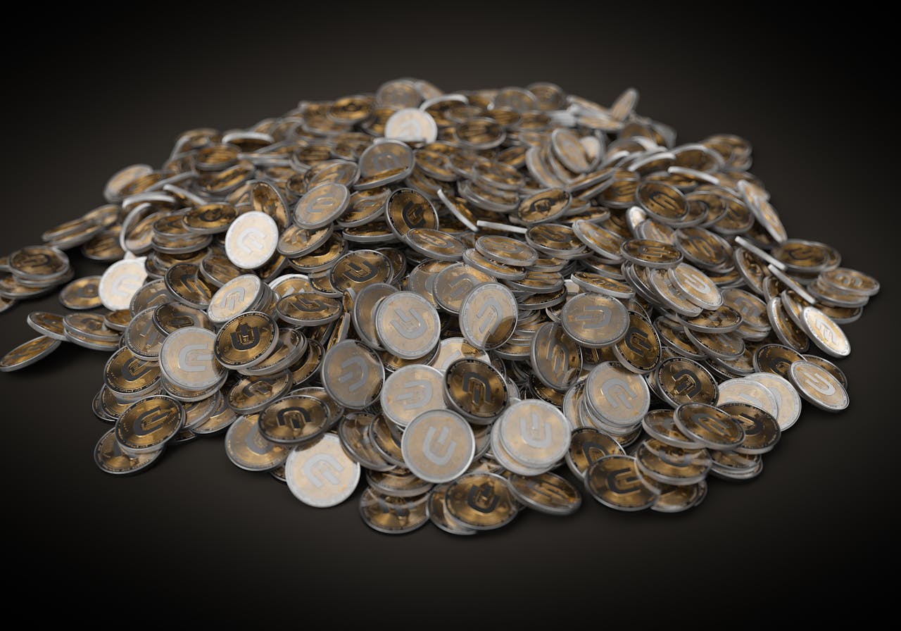 about-us A collection of silver and gold cryptocurrency coins stacked on a dark background, symbolizing digital wealth.